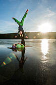 Couple doing yoga on frozen lake