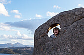 Boy on rock looking at camera