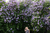 Girl standing by blooming trees