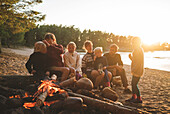 Family having campfire on beach