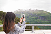 Woman taking photo with cell phone