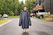 Girl wearing oversized raincoat
