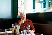 Mature man sitting in restaurant
