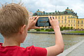 Boy taking photo with cell phone