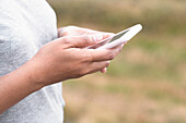 Woman using cell phone, close-up