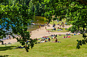 People relaxing at lake