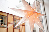 Star hanging on window