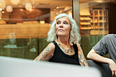 Tattooed woman during business meeting