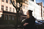 Pregnant woman standing on street
