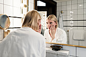 Blonde Frau im Badezimmer