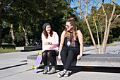 Female friends sitting on bench