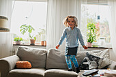 Girl playing on sofa