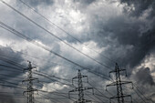 Electricity pylons against storm clouds