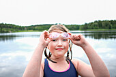Girl at lake wearing swimming goggles