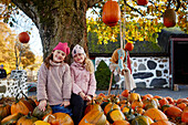 Smiling girl standing near pumpkins