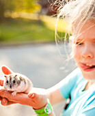 Girl holding hamster