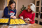 Two women preparing rolls