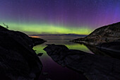 Atmospheric view of northern lights above sea