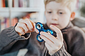 Boy playing fidget spinner