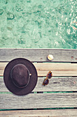 Hat, sunglasses, shell on jetty