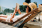 Woman reading on sunchair