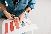Young woman cutting out painted stripes