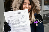 Teenage girl holding lease agreement