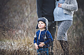 Small boy with parents during walk