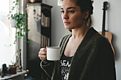 Woman with mug at home