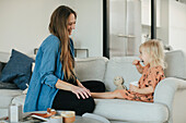 Mother and daughter sitting together