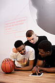 Basketball players using digital tablet