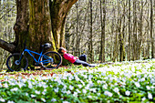 Cyclist resting in forest