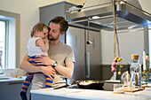 Father with daughter in kitchen