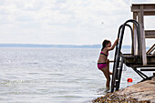 Girl playing at lakeshore