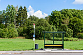 Empty bus stop by forest