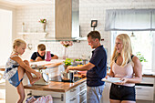 Family preparing meal in kitchen