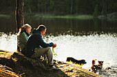 Couple sitting at lake