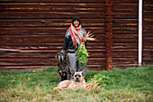 Woman with dogs and freshly picked carrots