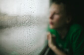 Boy looking trough train window