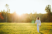 Woman walking in meadow