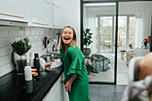 Happy teenage girl in kitchen