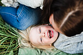 Happy girl playing with mother