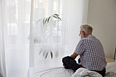 Man sitting on bed