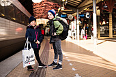 Brother and sister on train platform