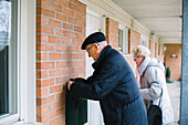 Senior couple checking mailbox