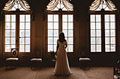 Bride looking through window