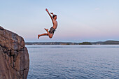 Boy jumping into sea