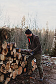 Man stacking logs