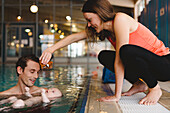 Parents with baby in swimming-pool
