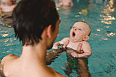 Father with baby in swimming-pool